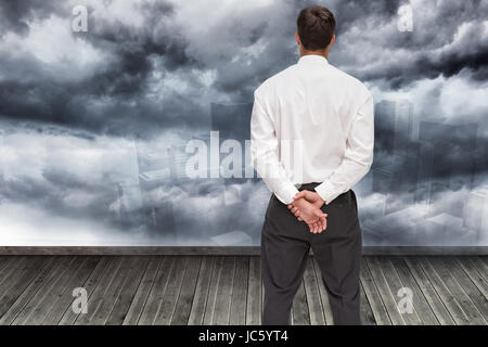 Composite image of businessman turning his back to camera Stock Photo