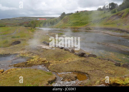 view of the secret lagoon. Iceland's oldest swimming pool, Iceland, showing steam from hot springs Stock Photo