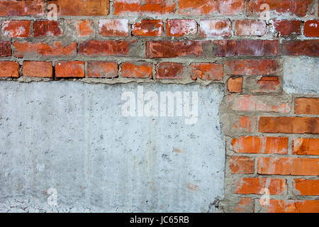 Brick wall with parts of concrete blocks Stock Photo