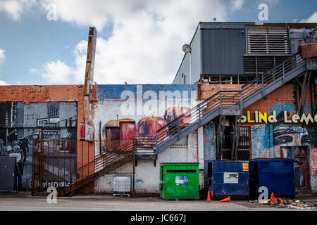 Paintings on wall along a sidewalk in Dallas Deep Ellum. Stock Photo