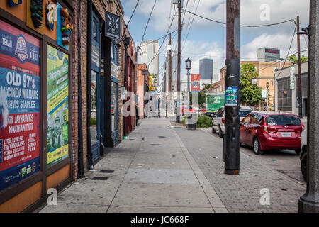 Paintings on wall along a sidewalk in Dallas Deep Ellum. Stock Photo