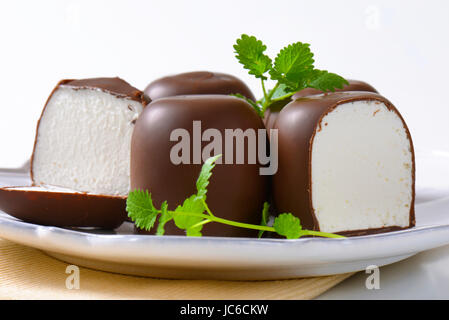 Marshmallows coated in milk chocolate Stock Photo