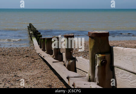 Line of weathered wooden groynes on Ferring Beach, West Sussex, UK Stock Photo