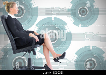 Composite image of blonde businesswoman sitting on swivel chair in black suit Stock Photo