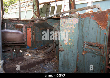Rusting, grunge operators chair inside abandoned trolley car. Stock Photo