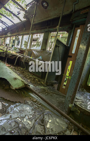 Debris inside damaged and wrecked commuter street car. Stock Photo