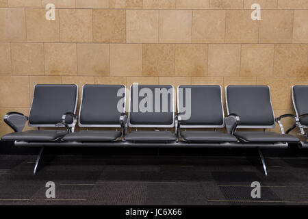 Row of Five Seats in Airport in boarding area Stock Photo