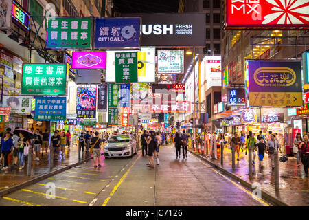 HONG KONG , CHINA - AUG 13 : Mongkok at night on August 13, 2014 in Hong Kong, China. Mongkok in Kowloon is one of the most neon-lighted place in the world and is full of ads of different companies. Stock Photo