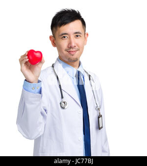 Male doctor with heart shape ball Stock Photo