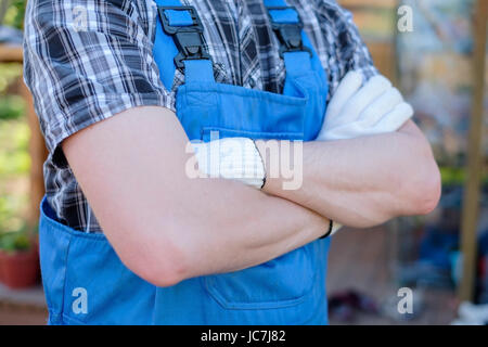Young gardener in dungarees ready for work Stock Photo