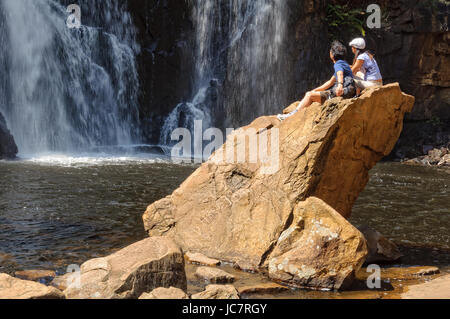 A young couple is admiring the majestic MacKenzie Falls in the Grampians Ranges Stock Photo