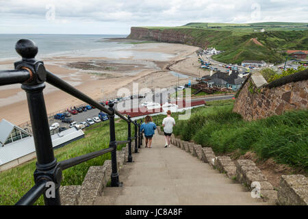 A man and woman walk down the steep steps to the beach area at Saltburn by the Sea, England, UK Stock Photo