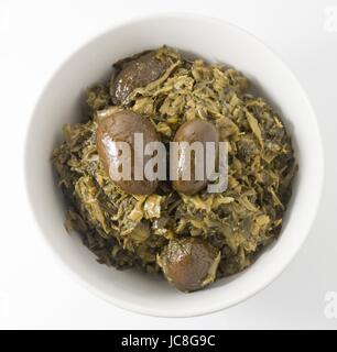 Chinese Traditional Food, A Bowl of Chopped Pickled Green Cabbage with Chinese Olives Isolated on White Background. Stock Photo