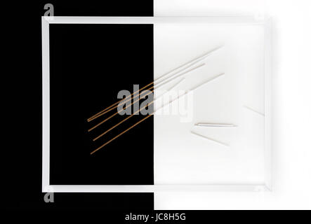 Minimal art. Spaghetti on black and white background in white frame. Stock Photo
