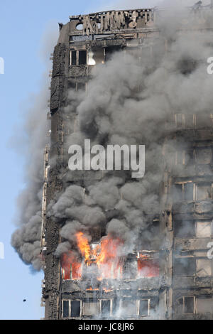 London, UK. 14th June, 2017. Fire is still burning inside the tower at 9am. At least 50 people have been taken to five hospitals for treatment as hundreds of residents in the 24-storey, 120 flat, Grenfell Tower in North Kensington have been evacuated from their flats in the building that caught fire just after 1.15am. Many casualties are expected. Credit: Bettina Strenske/Alamy Live News Stock Photo