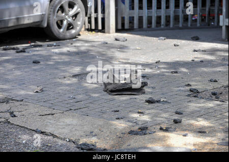 London, UK.  14 June 2017.  Debris from the fire is strewn on the road.  The Grenfell Tower near Latimer Road in west London was engulfed in a huge fire the previous night, resulting in at least twelve fatalities with many more in critical condition.   Credit: Stephen Chung / Alamy Live News Stock Photo