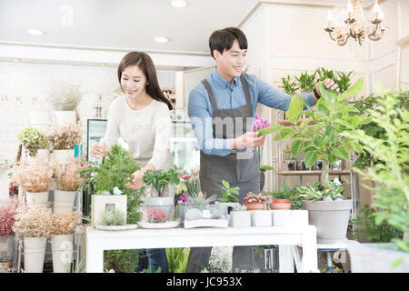 Young smiling florists working at shop Stock Photo