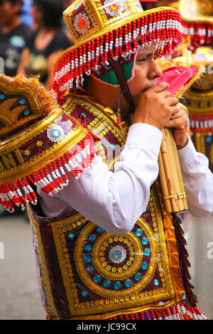 Local man playing flute during Festival of the Virgin de la Candelaria in Lima, Peru. The core of the festival is dancing and music performed by diffe Stock Photo