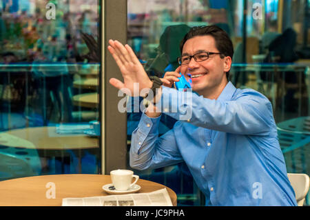 handsome young successful man doing a welcome gesture. Inviting businessman.Hello I'm  Here Stock Photo