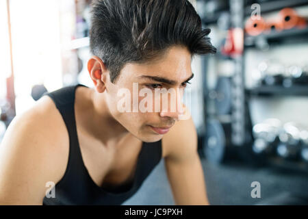 Young fit hispanic man in black sleeveless shirt in gym Stock Photo