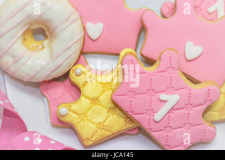 First birthday royal icing cookies - pink and golden crown shaped cookies with number 1 Stock Photo