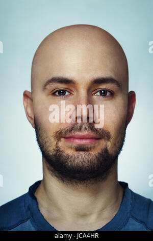 Young unshaven bald man front portrait close-up Stock Photo