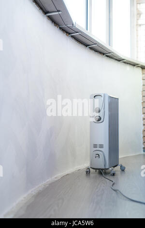 Electrical heater under windows in home with new interior Stock Photo