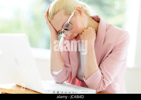 Stressed woman at work Stock Photo