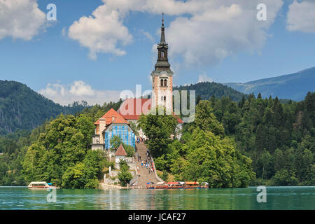 Bled, Slovenia - June 3, 2017: Close up of the church in the center of Bled Lake with several tourists walking by Stock Photo