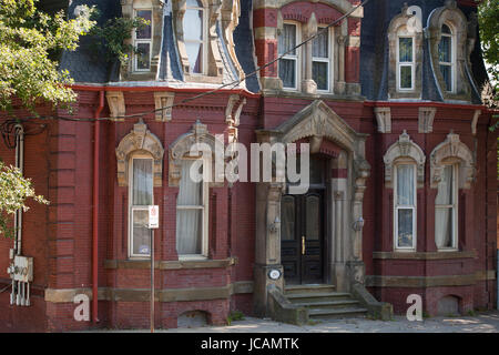 Beautiful old victorian house facade with intricate window and door ornaments. Stock Photo