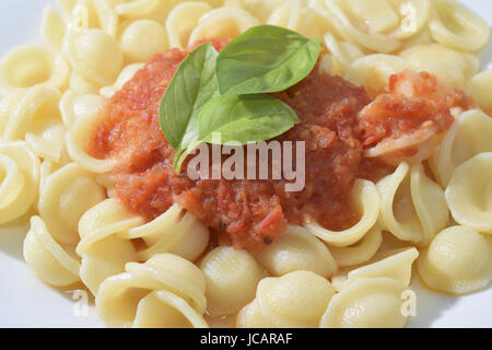 A recipe of the Italy  southern : orecchiette with tomato sauce Stock Photo