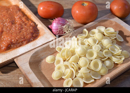 A recipe of the Italy  southern : orecchiette with tomato sauce Stock Photo