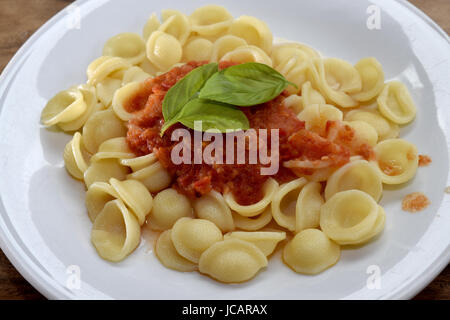 A recipe of the Italy  southern : orecchiette with tomato sauce Stock Photo