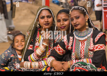 Troupe of female Kalbelia dancers from Rajasthan dressed in traditional black outfits decorated with colourful beads and sequins. Stock Photo