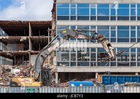 Demolition excavator at work during the demolition of CLASP office buildings, Nottinghamshire, England, UK Stock Photo