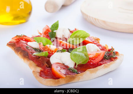 pizza pomodoro, vegetarian and homemade with mozzarella, tomatoes and basil isolated on white background Stock Photo