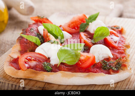 pizza pomodoro, vegetarian and homemade with mozzarella, tomatoes and basil isolated on white background Stock Photo