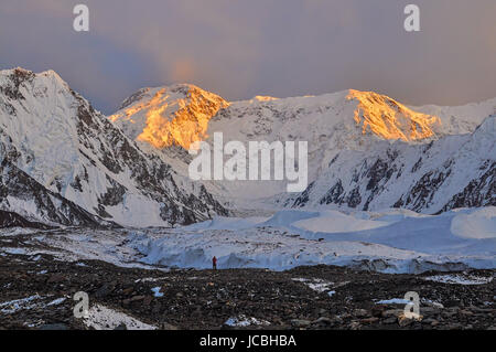 Inylcheck glacier in Kyrgyzstan with Pik Pobeda peak lit by early morning sun Stock Photo