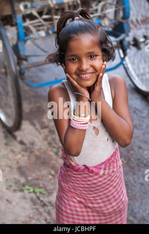 Smiling girl from a poor family in a street in Old Delhi, India. Stock Photo