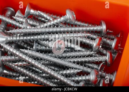 A pile of screws in a box Stock Photo