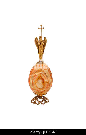 Egg with a multi-colored onyx stone with an angel and a cross on a white background Stock Photo