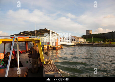 small passenger ferry boat sailing to Mount Batten Plymouth Devon with holiday tourists on board at sunset Stock Photo