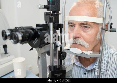 close-up of an optometrist checking senior male patient vision Stock Photo