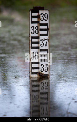 Meter or ruler for measuring water depth in a drainage canal against ...