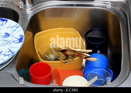 Dirty dishes in a kitchen sink Stock Photo