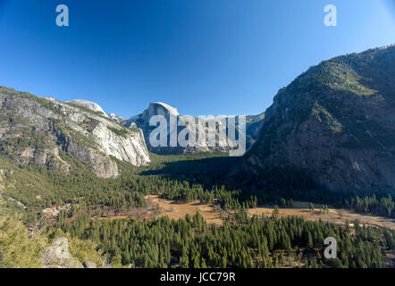 A view from the Yosemite's valley floor looking Southeast to Half Dome. Yosemite is home to waterfalls, granite peaks, and beautiful meadow. This was  Stock Photo
