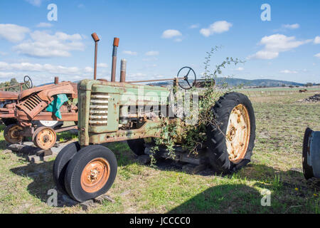 An Old John Deere Farm Tractor waiting for Restoration in a rural paddock. Stock Photo