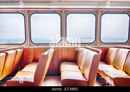 ferry boat cabin and rows of seats looking out the window Stock Photo