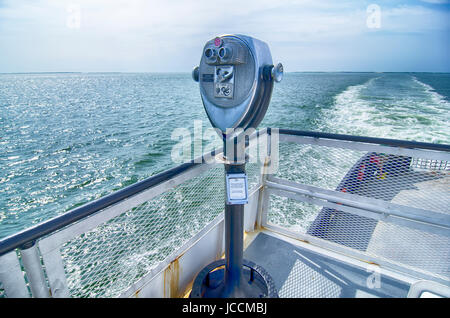 Binoculars watching at horizon on ship deck Stock Photo