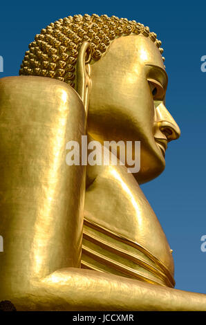 A gold covered statue of Buddha is the central figure at the Golden Temple in the Dambulla temple complex near Kandalarma in Sri Lanka. Stock Photo